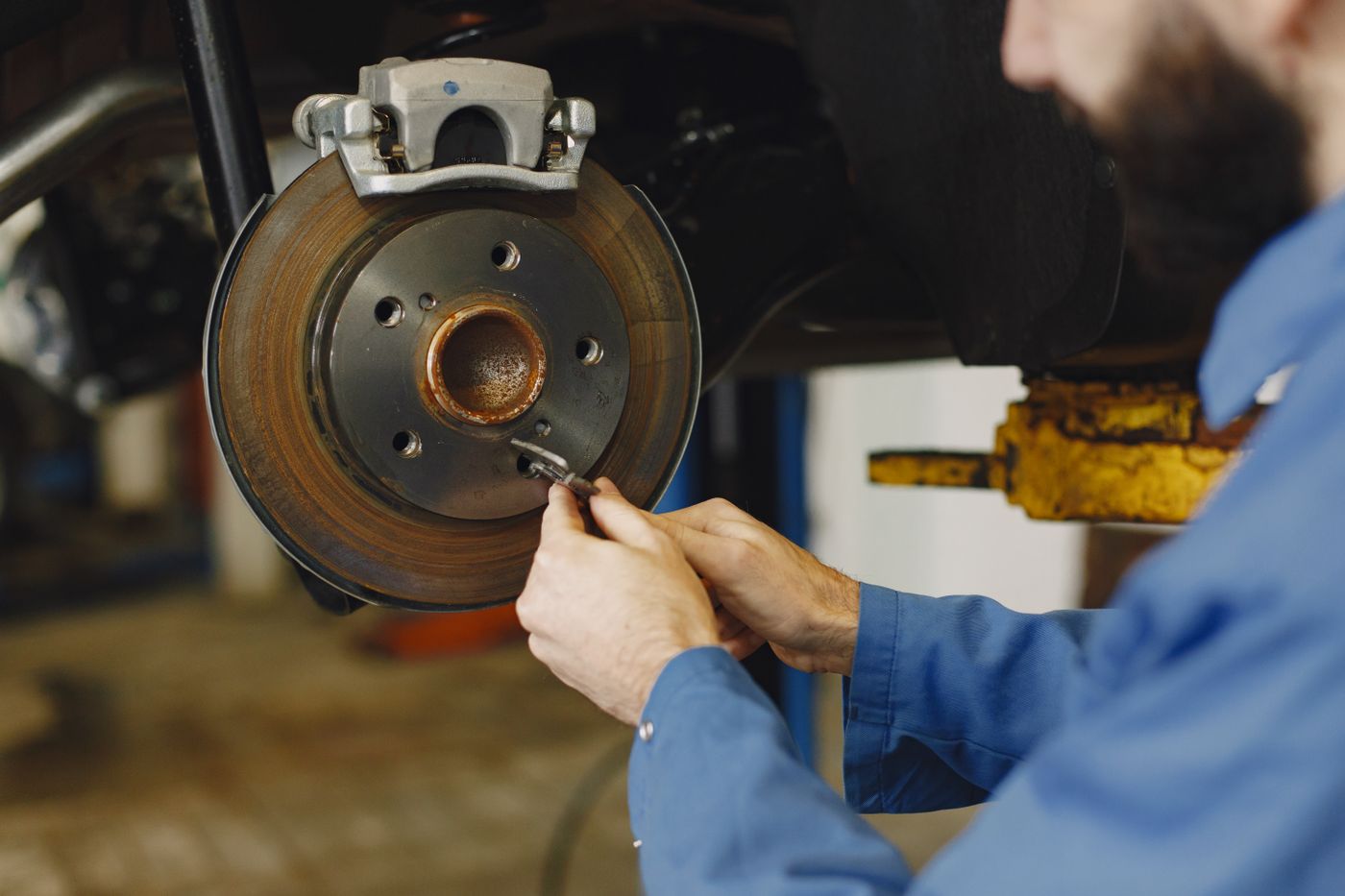 Mechanic working carefully on a vehicle brake