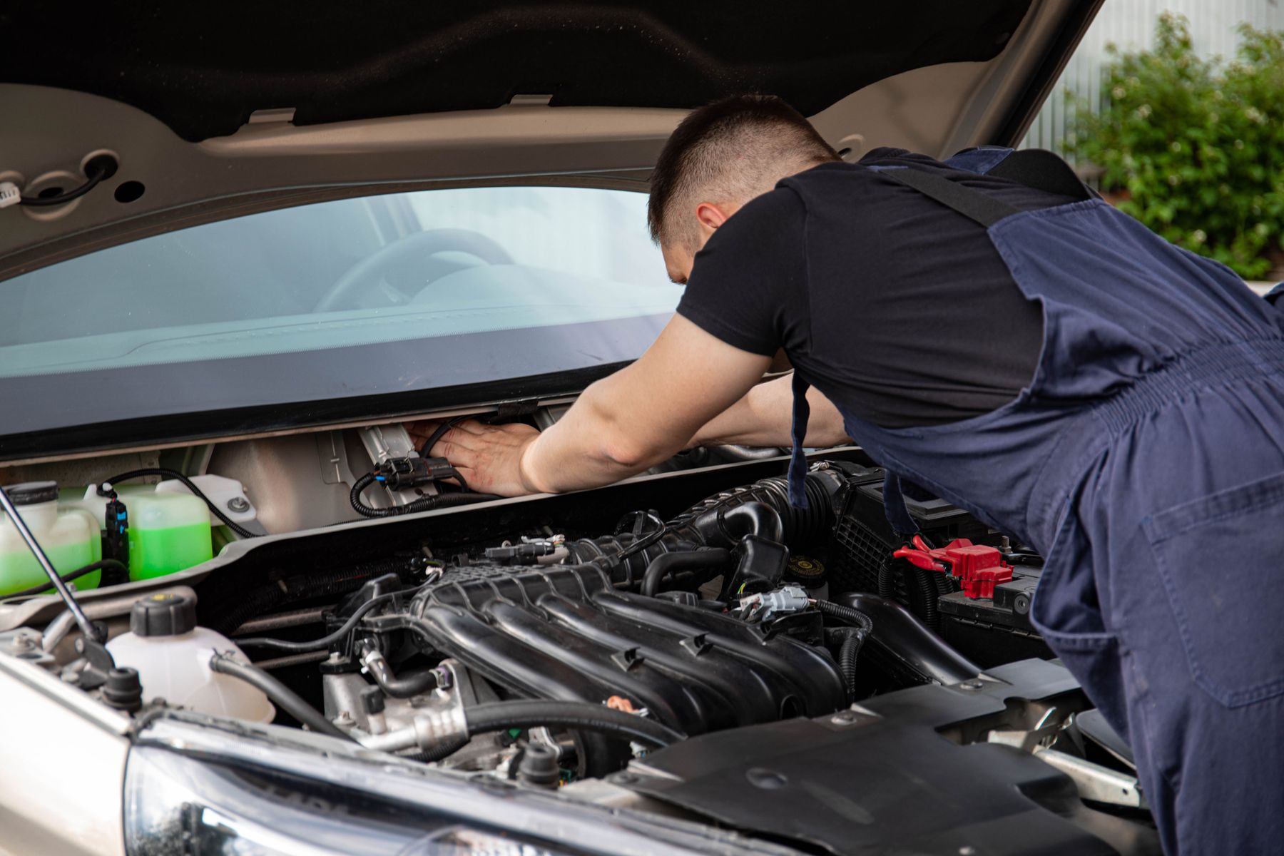 Mechanic working carefully in a vehicle engine bay